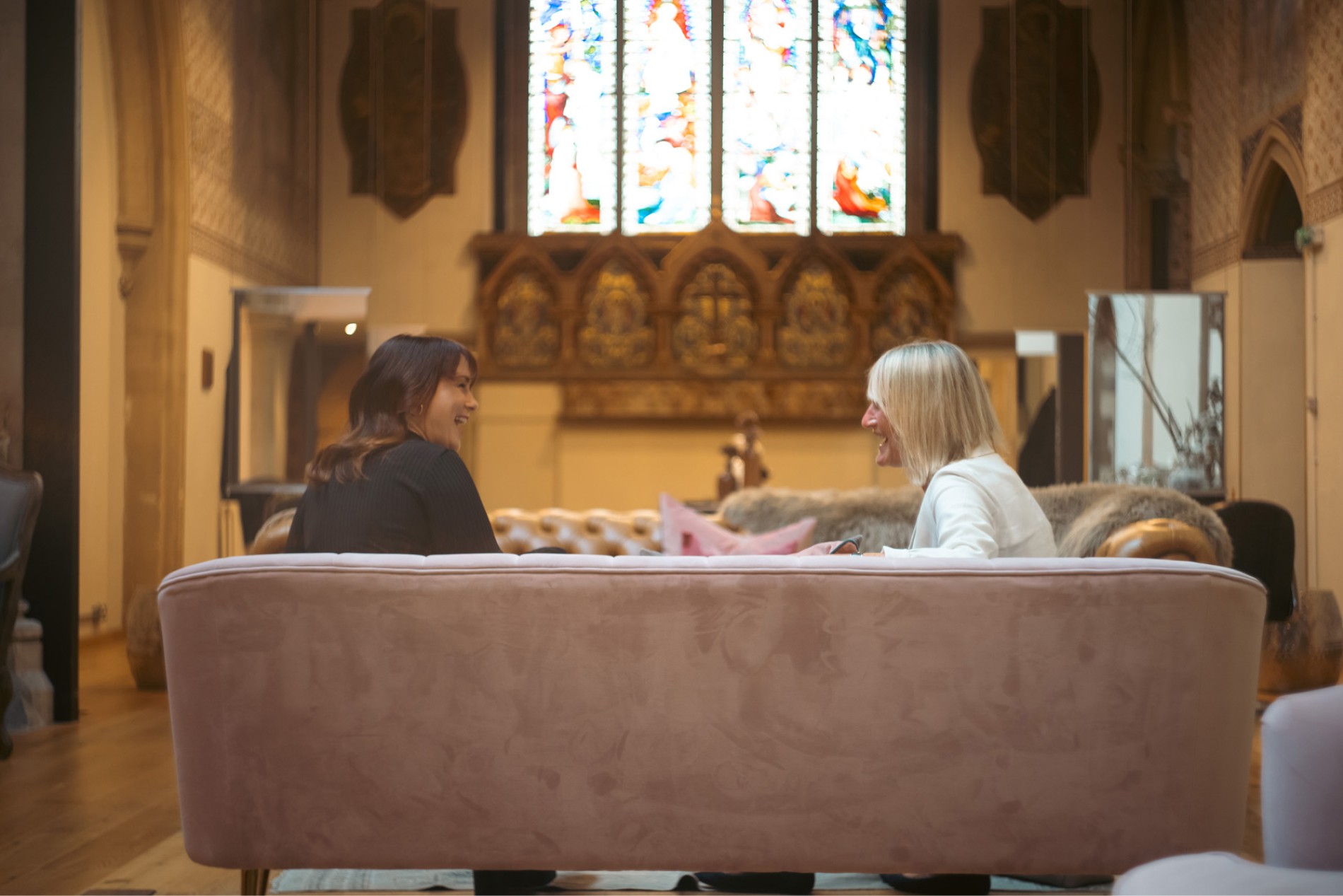A guest consulation in front of the stained glass window at The Chapel Marlow